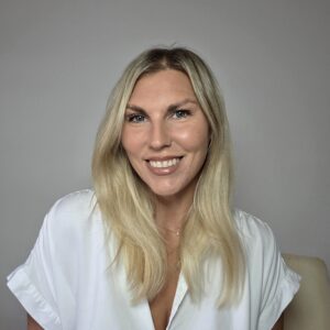 Healthy voluminous blonde hair on a woman over 40 showing results of consistent scalp care routine and targeted hair products