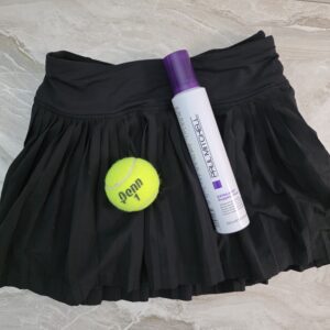 Paul Mitchell extra body sculpting foam mousse with tennis ball on black tennis skirt discovered as unexpected conditioning treatment for women over 40 with thin fine hair