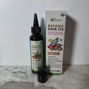 Batana hair oil for scalp treatment and hair growth for women over 40 styled on neutral surface
