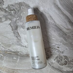 Remilia Rice and Shine leave-in conditioner for women over 40 with thin fine hair on marble background