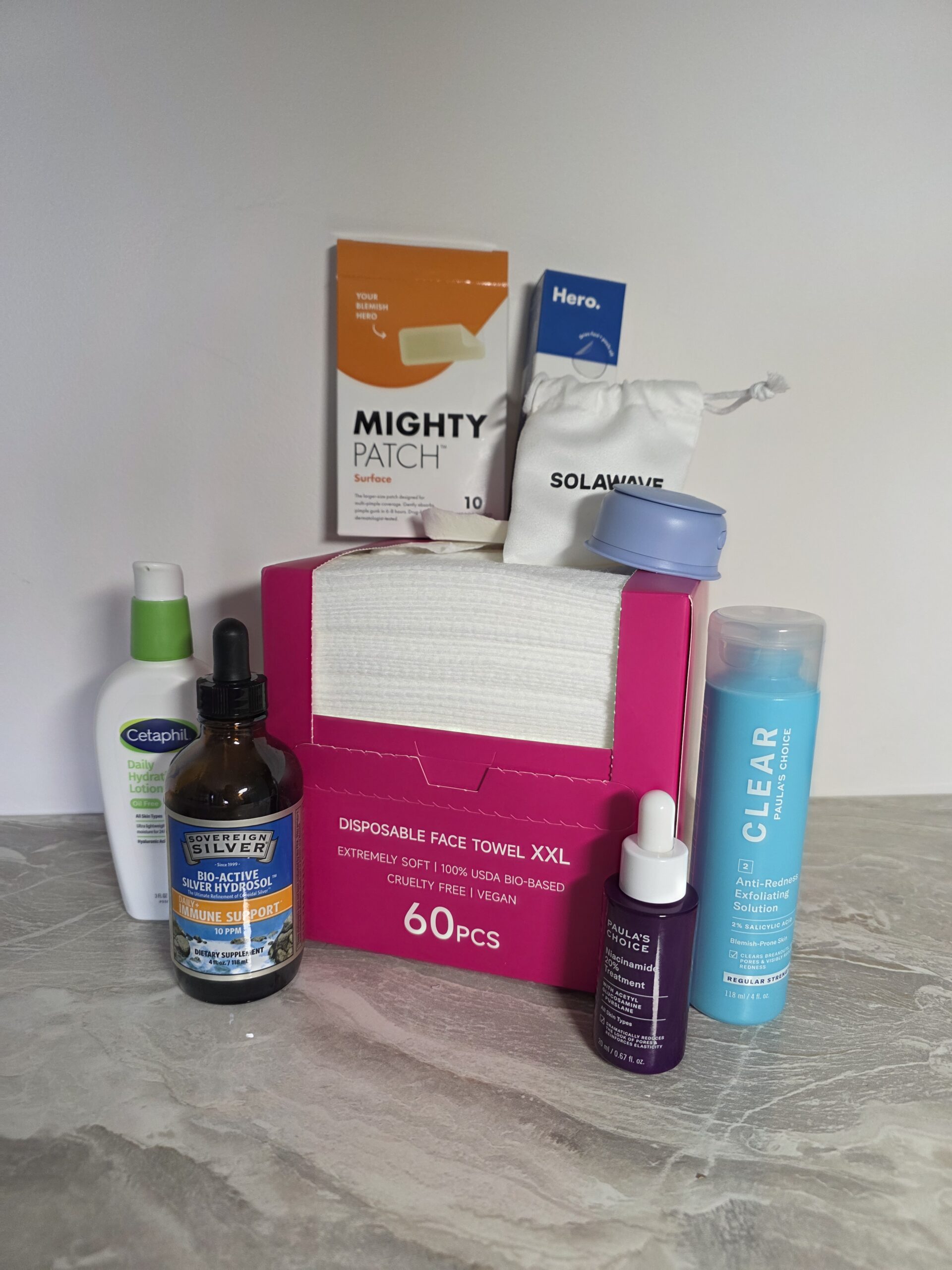 Flat lay of hormonal acne skincare routine products