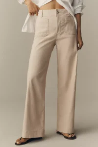 Model wearing cream high-waisted wide-leg trousers with a white shirt