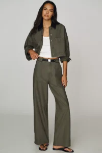 Woman in an olive utility jacket and matching wide-leg trousers