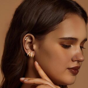 Woman over 40 in profile wearing a modern gold ear climber earring
