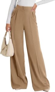 Model in tan wide-leg trousers with a white top and cream shoulder bag