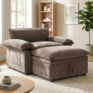 Oversized taupe upholstered accent chair with a matching ottoman in a neutral, softly lit room