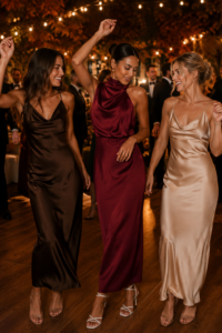 Woman over 40 wearing a deep berry satin maxi wedding guest dress