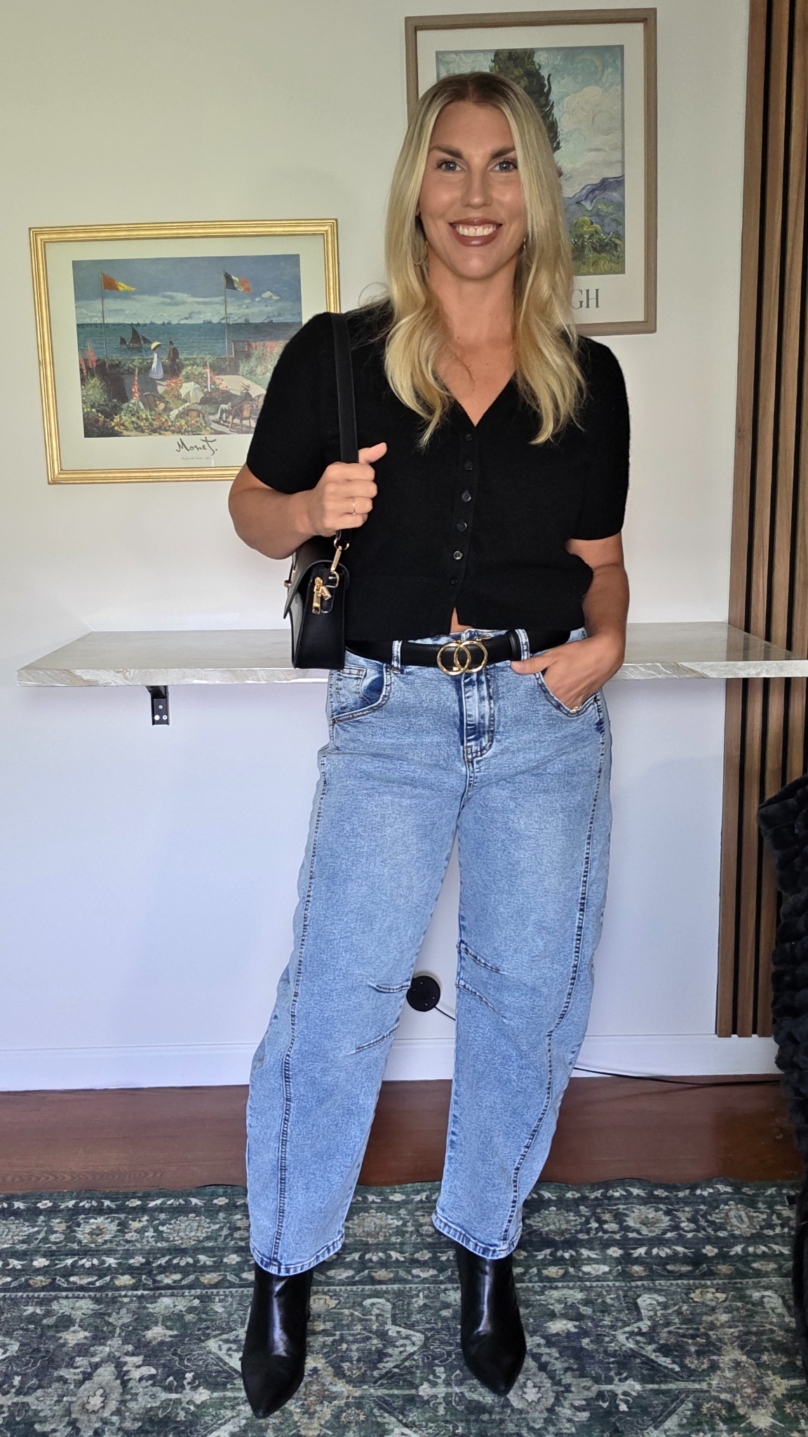 Barrel-leg jeans with cropped black button-front knit, black ankle boots and shoulder bag