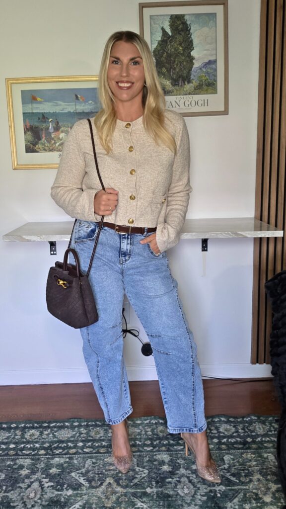 Barrel-leg jeans with a cropped cream cardigan, brown bag and clear pointed heels