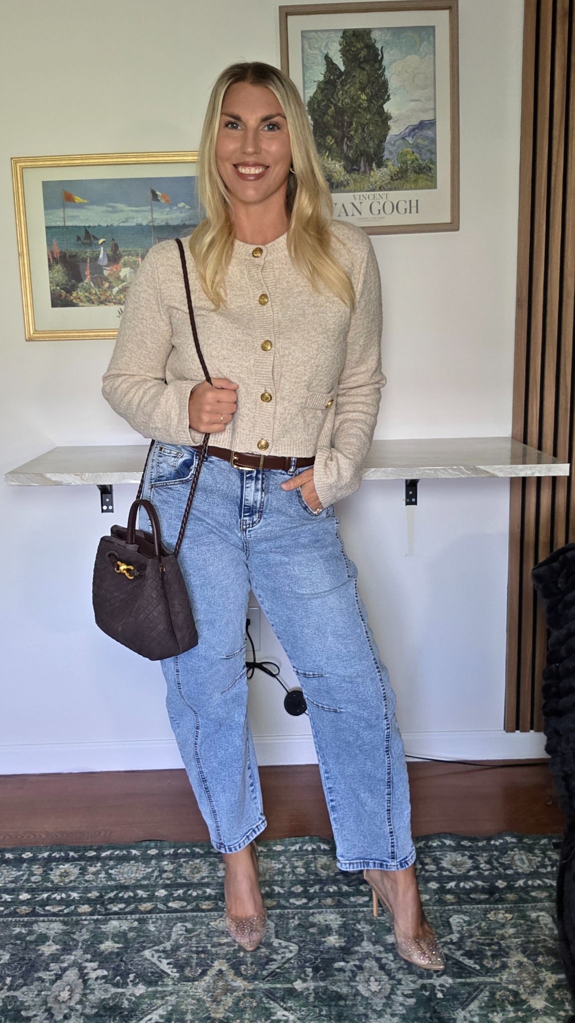 Barrel-leg jeans with a cropped cream cardigan, brown bag and clear pointed heels